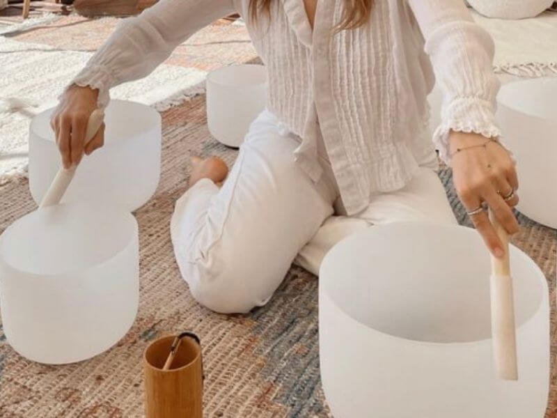 Kylie Roy playing crystal singing bowls during a sound bath meditation session at Soul2Source in Penrith.